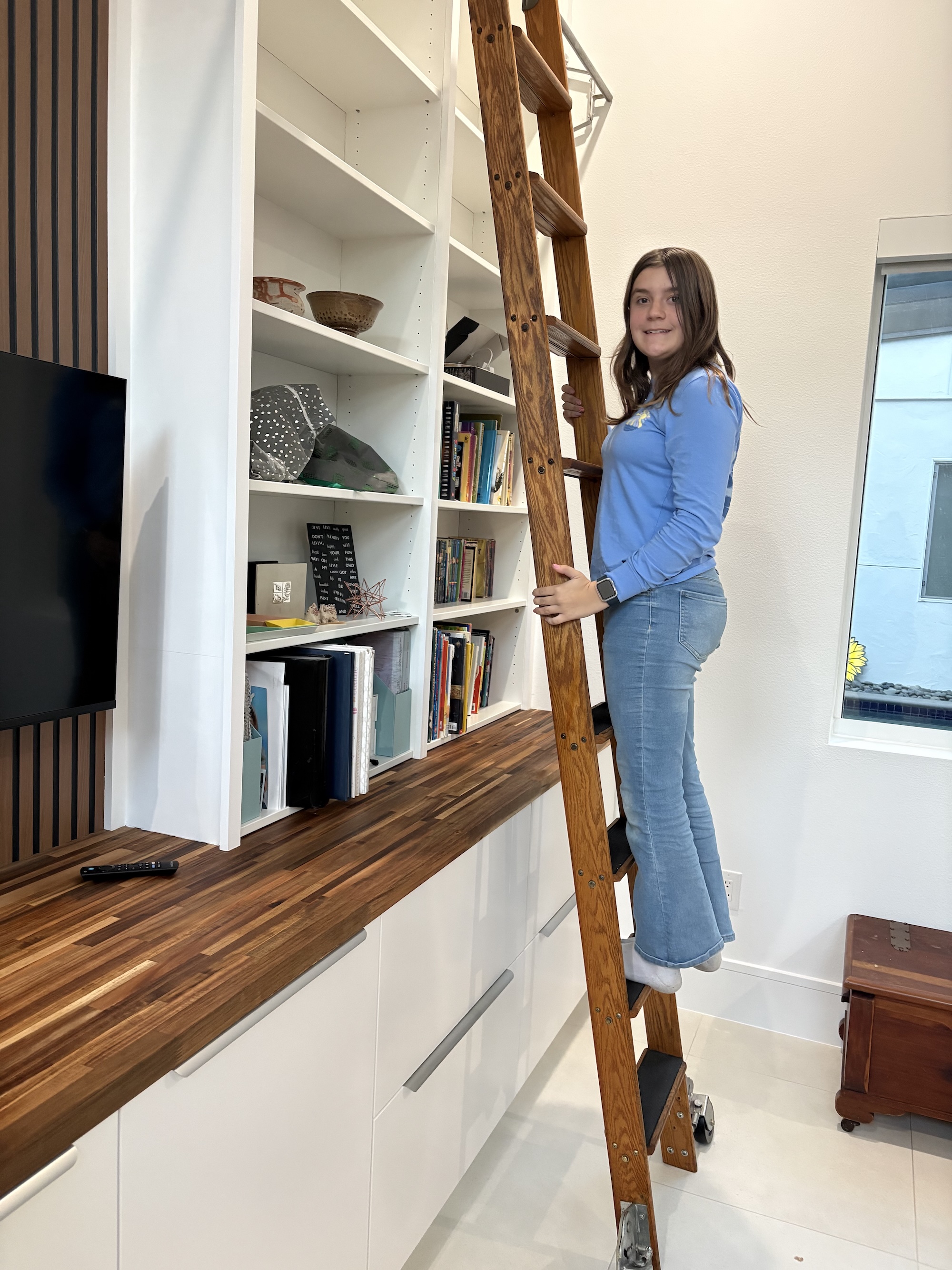 Photo of our daughter Adelyn standing on the installed ladder.