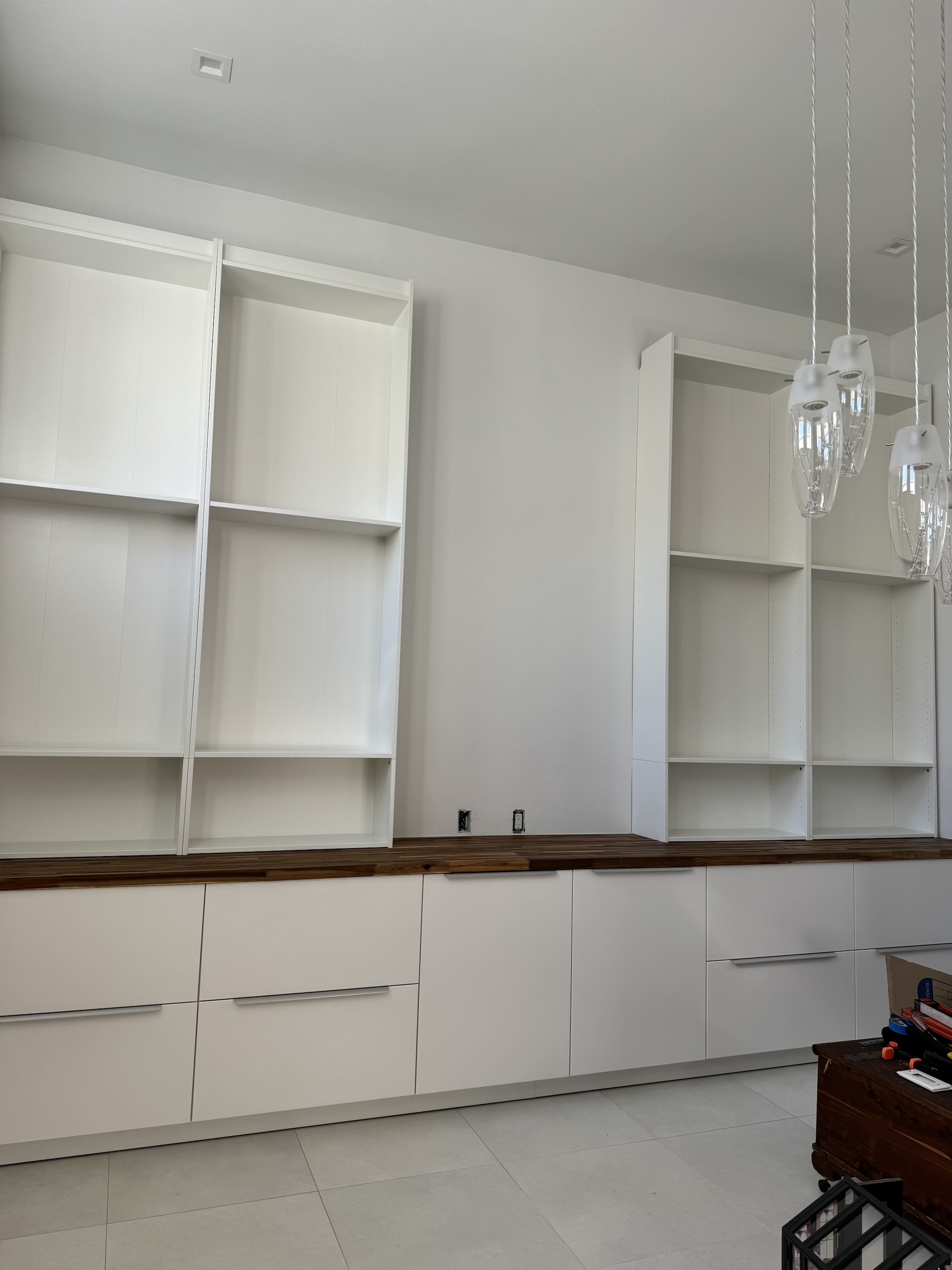 Photo of Billy bookcases on top of the base cabinets.